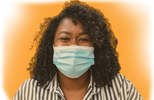 smiling woman wearing a surgical mask