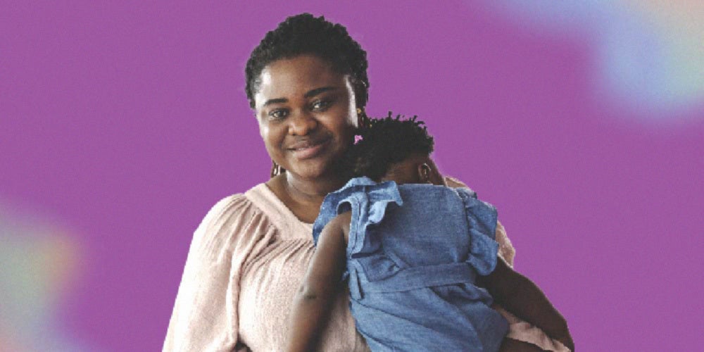 mother holding her child and smiling at camera