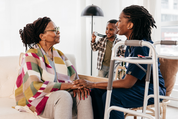 Child and grandchild having a nice visit with elderly family member