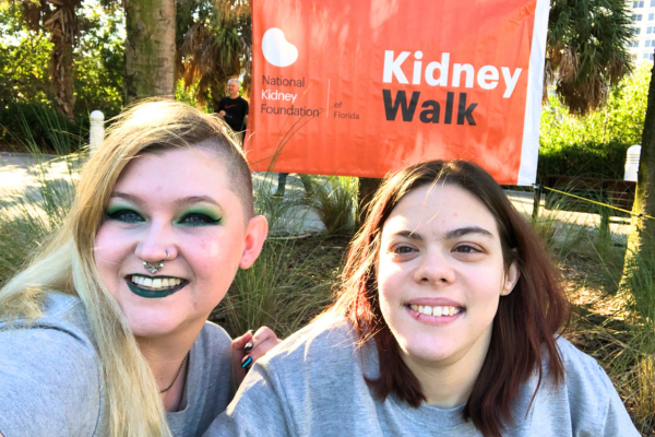Daylina (L) and Alese (R) next to Kidney Walk banner
