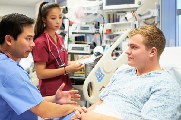 Patient in hospital bed receiving consultation 