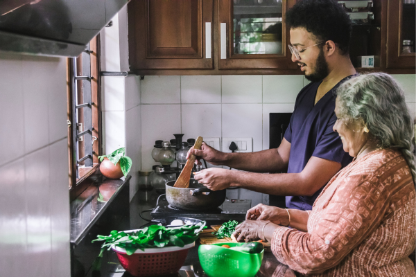 Grandchild and grandparent cooking together