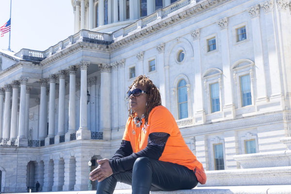 Voices for Kidney Health advocate sitting on Capitol's steps.