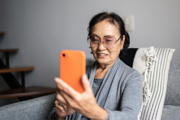 Older adult smiling at phone