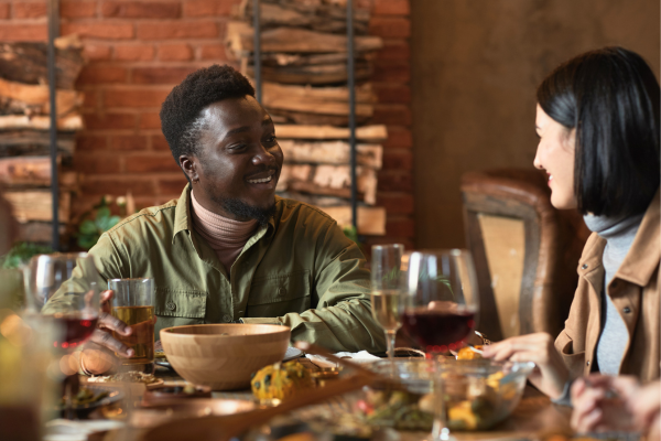 Two friends happily speaking over dinner