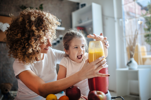 adult and child making a smoothie