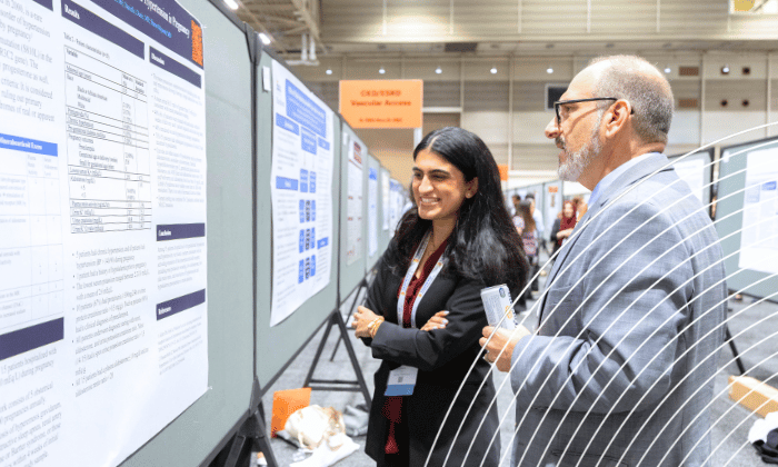 SCM attendees reviewing an abstract poster