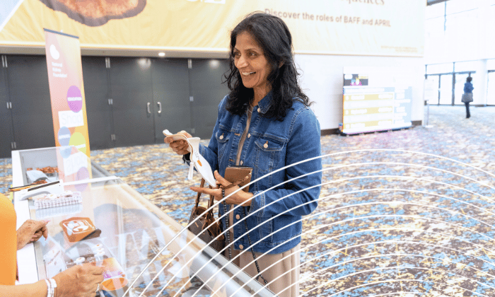 SCM attendee purchasing merchandise at desk