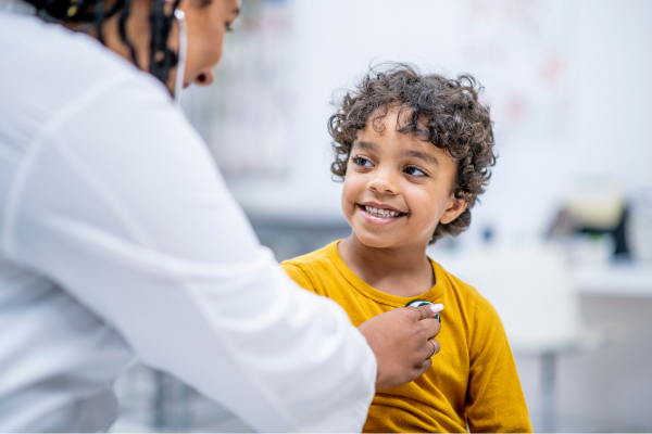 Smiling child getting heart beat taken