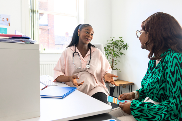 Patient speaking with a smiling healthcare provider