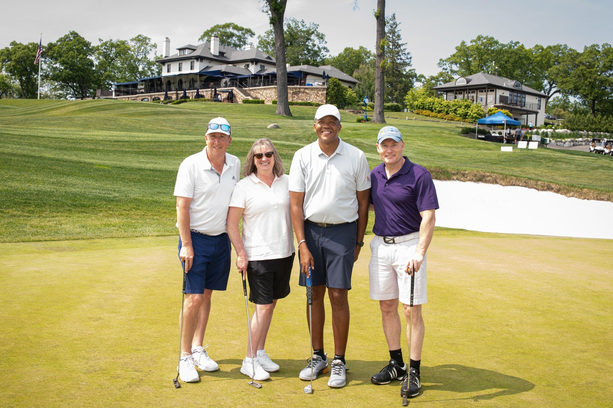 Four golfers standing on the golf course at the 2023 NJ Golf Classic