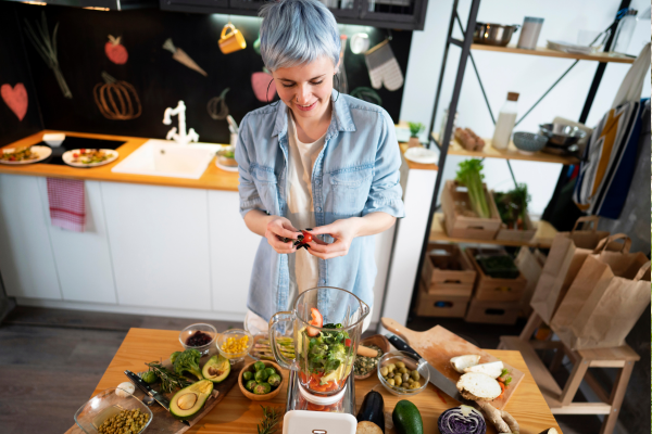 Person smiling while making a pesto