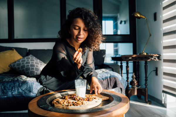 Person eating almonds in the living room