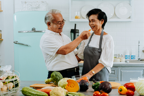 Person cheekily feeding their partner a carrot