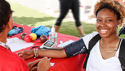 a woman having her blood pressure taken at a KEEP Healthy kidney health screening event