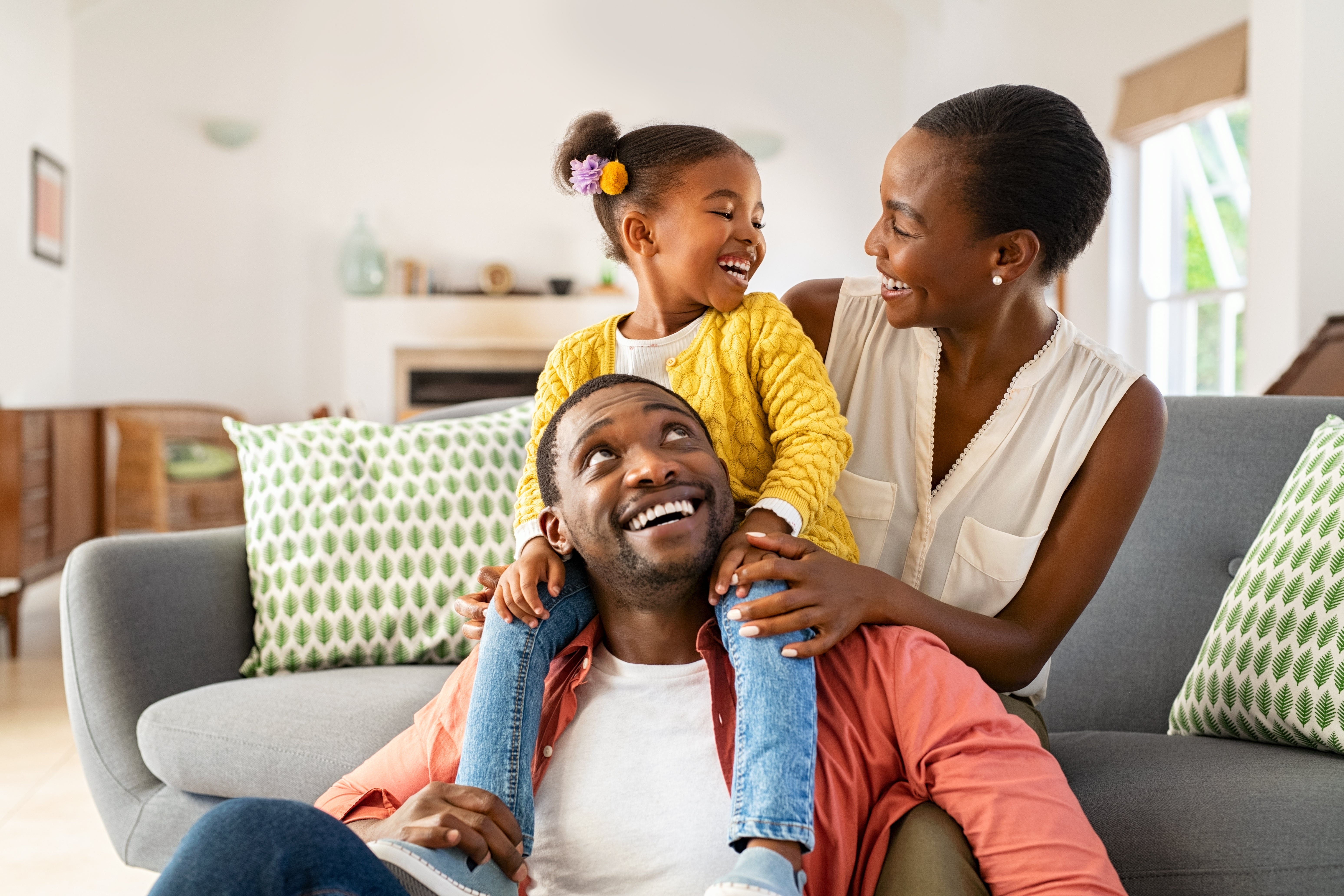 A girl playing with her parents at home