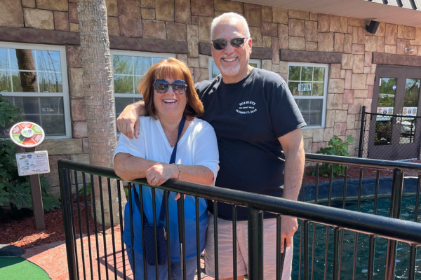 Alan Levy and wife outside of a restaurant  