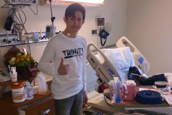 Andrew in hospital with thumbs up