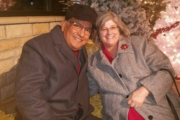 Anthony and Eileen Lovato bundled up outside on a bench