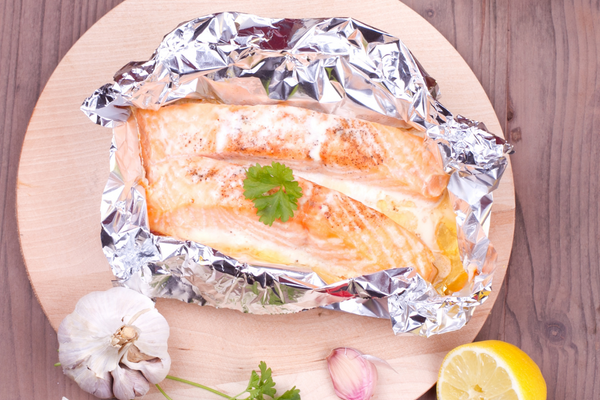 Baked salmon in foil with garlic and lemon on the side