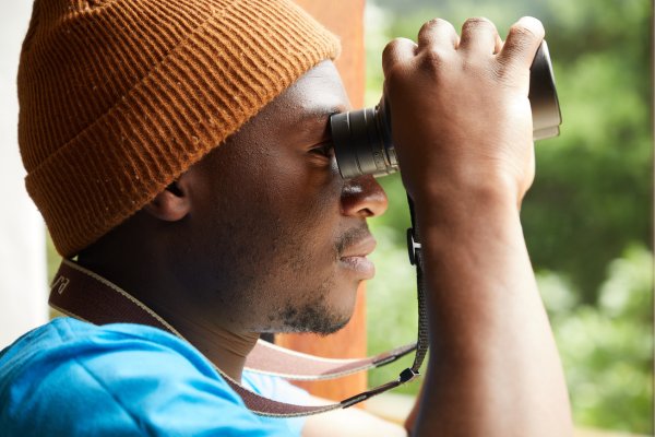 Person looking through binoculars 