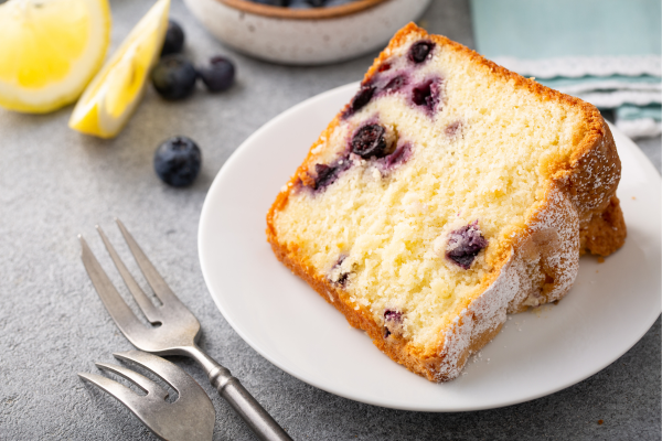 Slice of blueberry lemon pound cake on a plate.