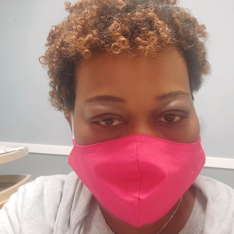 Candria in the hospital wearing a mask