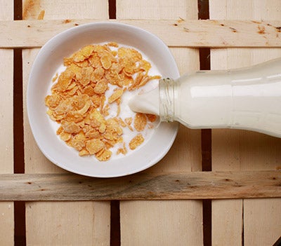 a bowl of corn flake cereal with milk