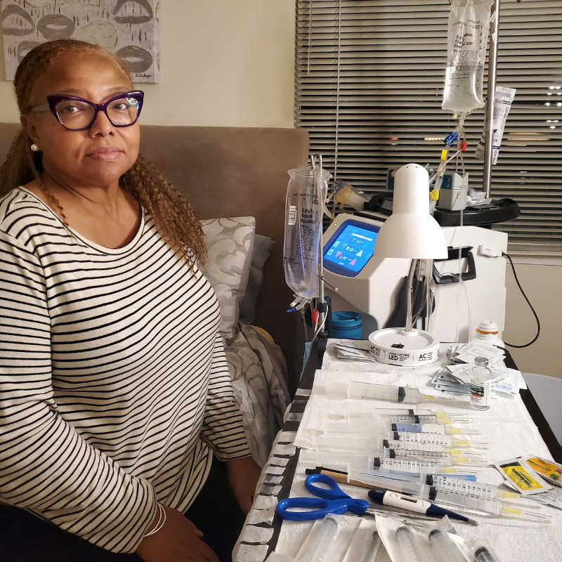 Charlotte next to table of home hemodialysis table