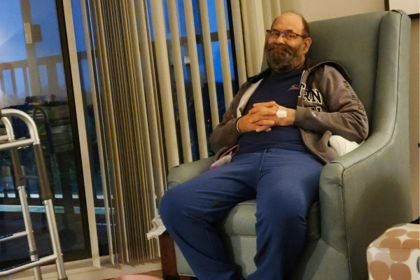 Robert in a chair smiling after kidney transplant