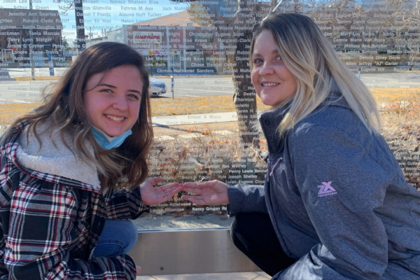 Christina and her daughter in front of deceased donor memorial wall