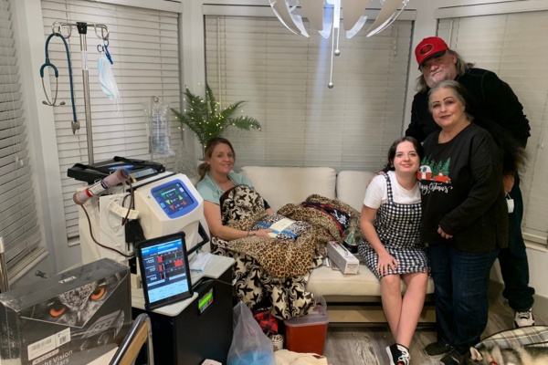 Christina surrounded by family at Christmas doing home hemodialysis