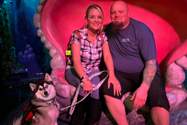 Christina, Michael, and Moose sitting in a giant clam at Las Vegas 