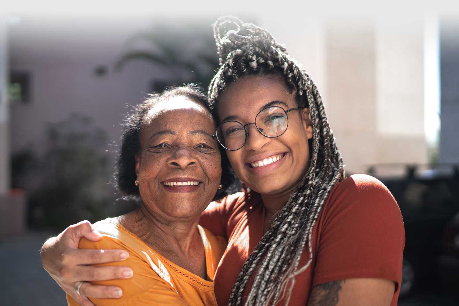 Two people hugging and smiling at the camera