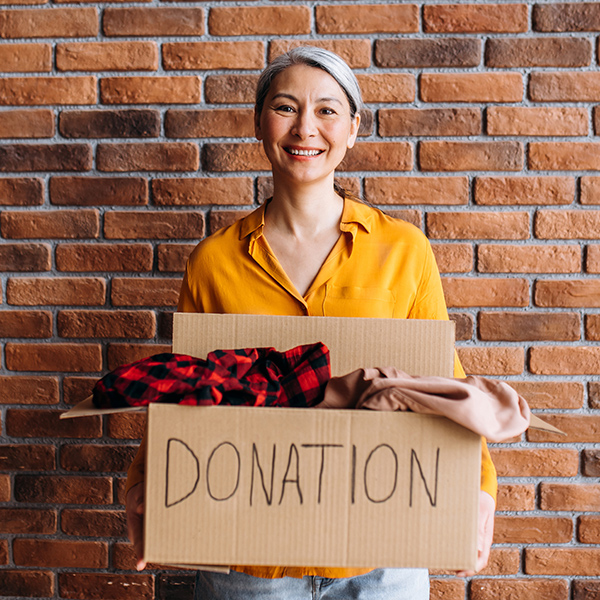 woman donating a box of clothes
