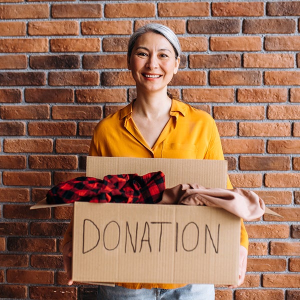 woman donating a box of clothes