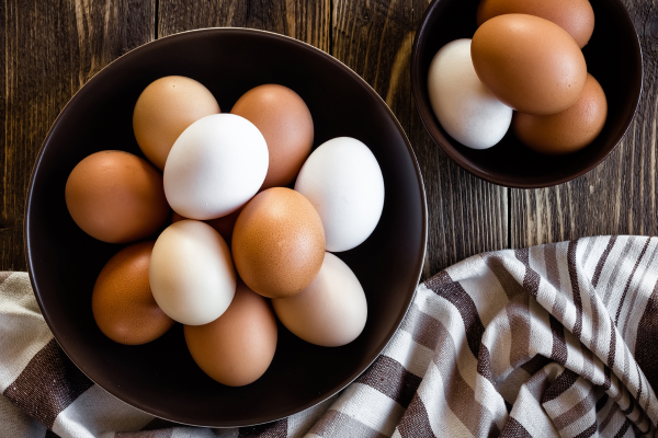 Bowls of white and brown eggs