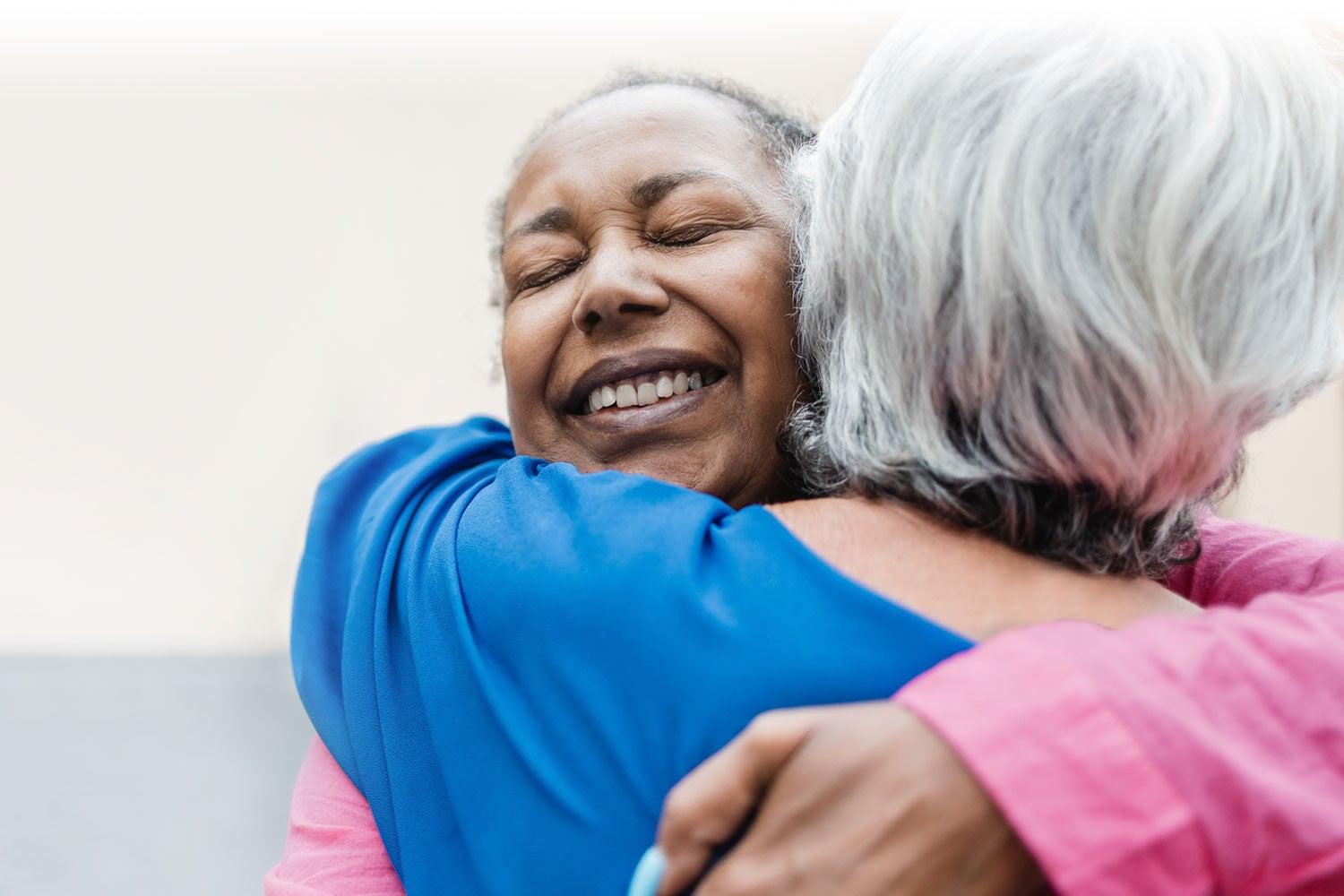 Two people looking supported while hugging each other Two people looking supported while hugging each other