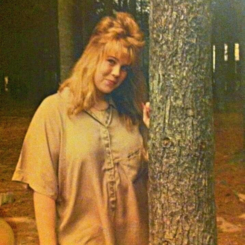 Joseph's mother in the 80's by a tree