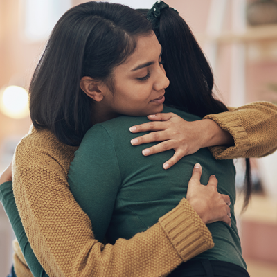 Two friends hugging