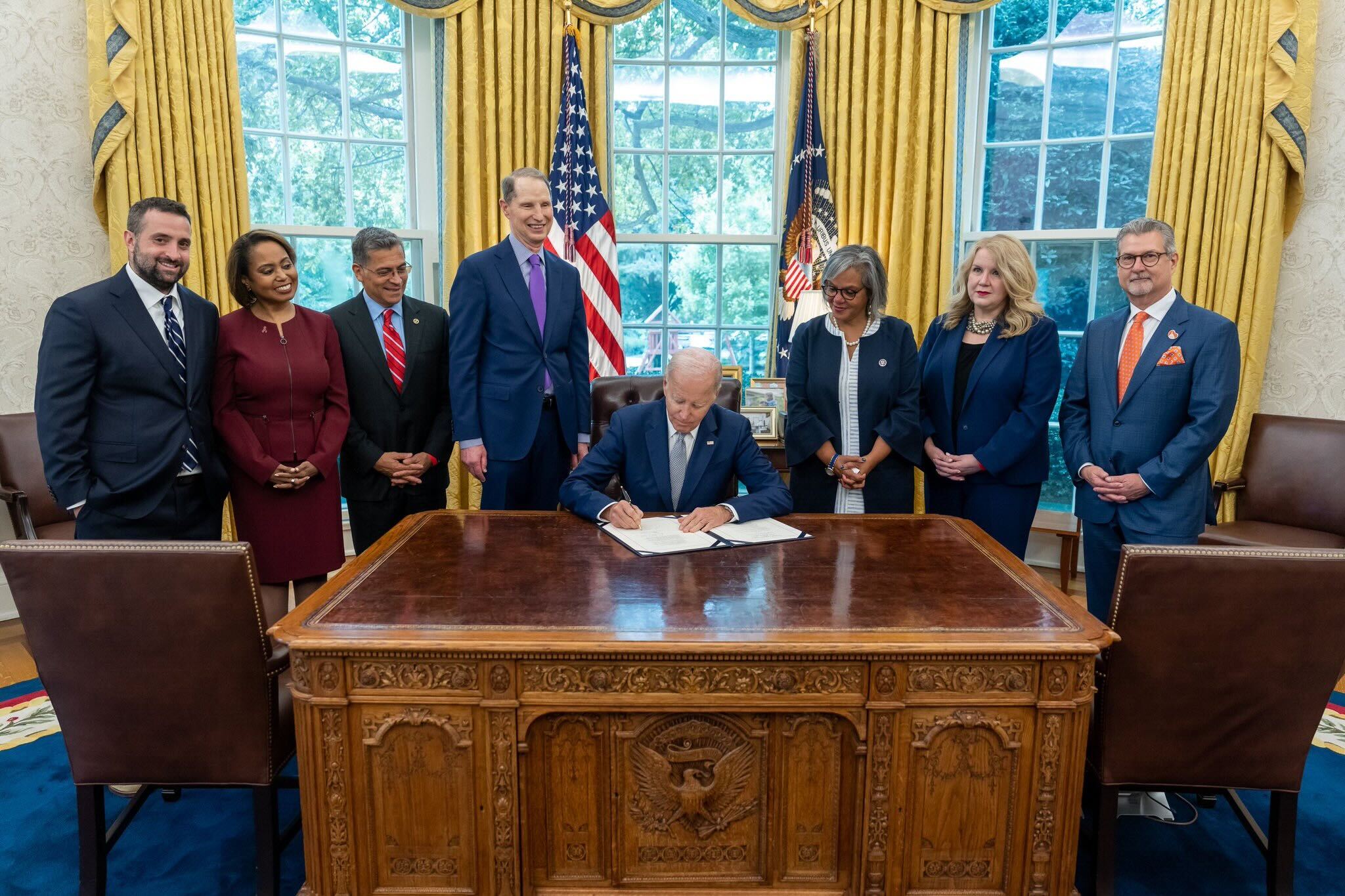President Joe Biden and his team signing the OTPN Act alongside NKF's CEO Kevin Logino 
