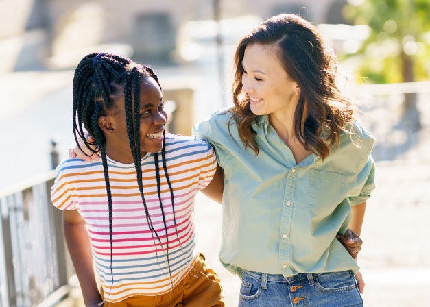 Woman and girl smiling at each other