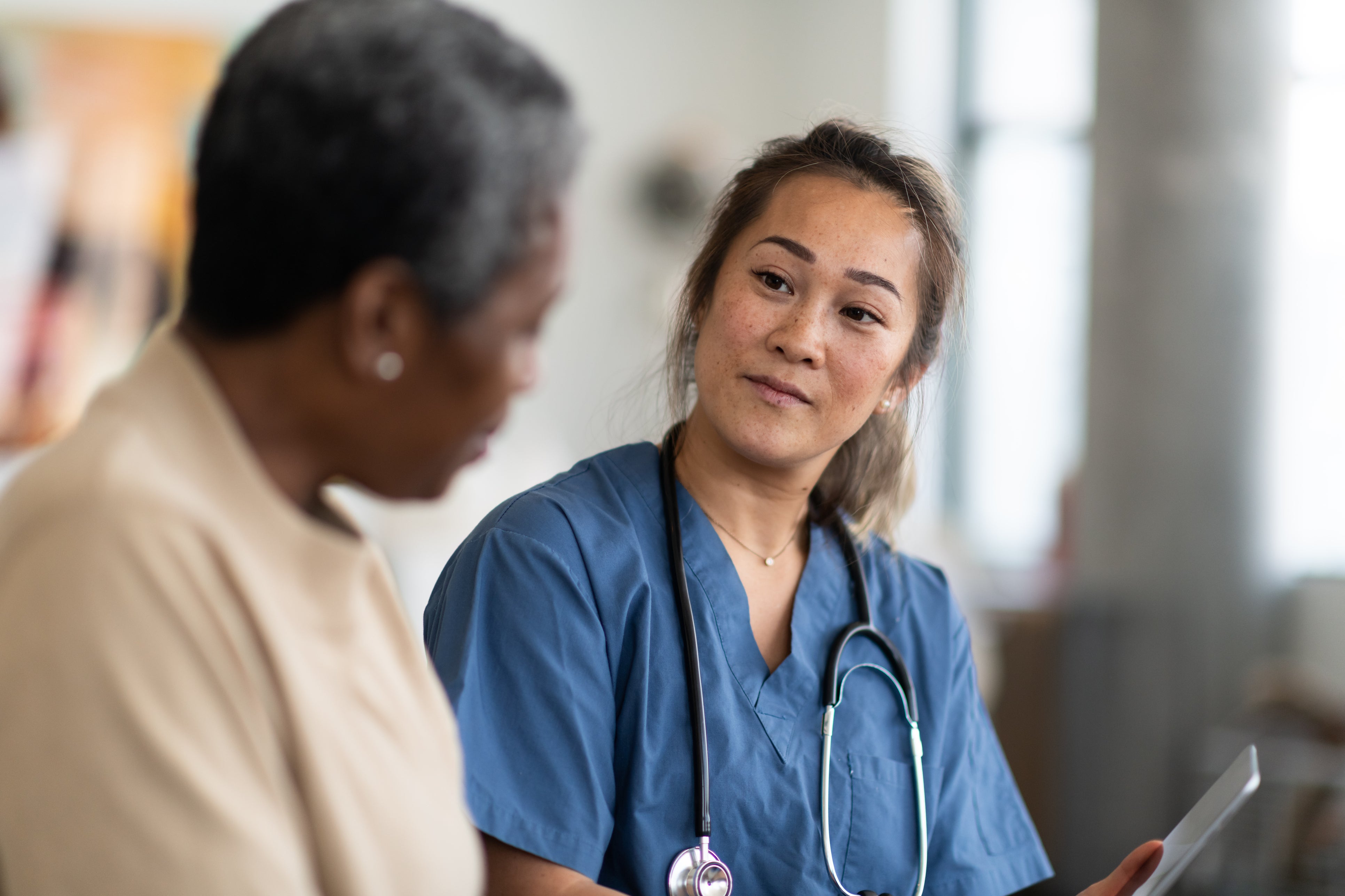 Doctor listening and speaking with a patient