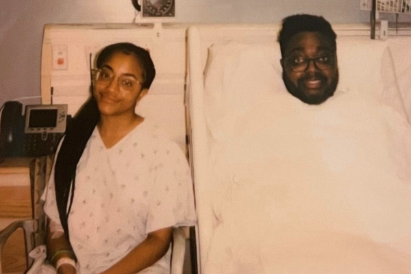 Jada Sasha sitting by her brother in the hospital after transplant