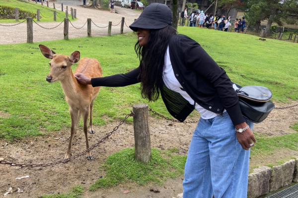 Janet Tennyson petting a deer