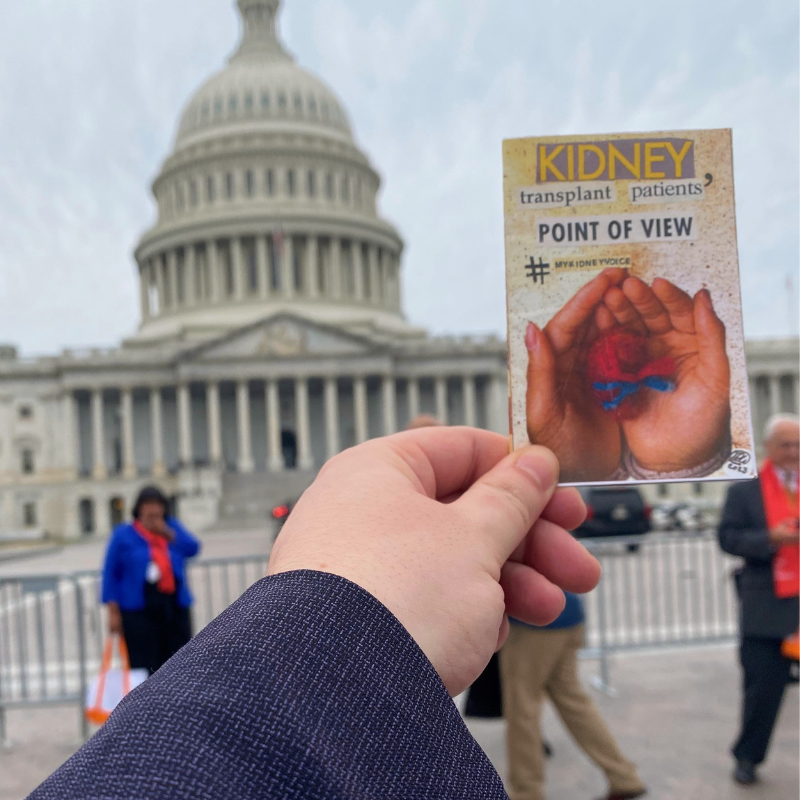Jess holding their self-published 8-page zine "Kidney Transplant Patient's POV"  in front of the U.S. Capitol for the 2023 NKF Patient Summit. The zine was distributed to staffers in each meeting with extra copies intended for representatives. 