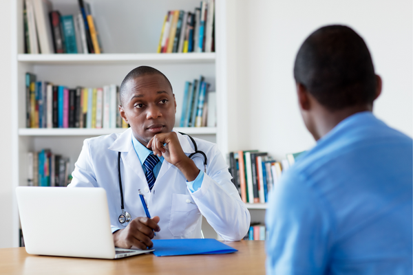 Worried doctor speaking with patient