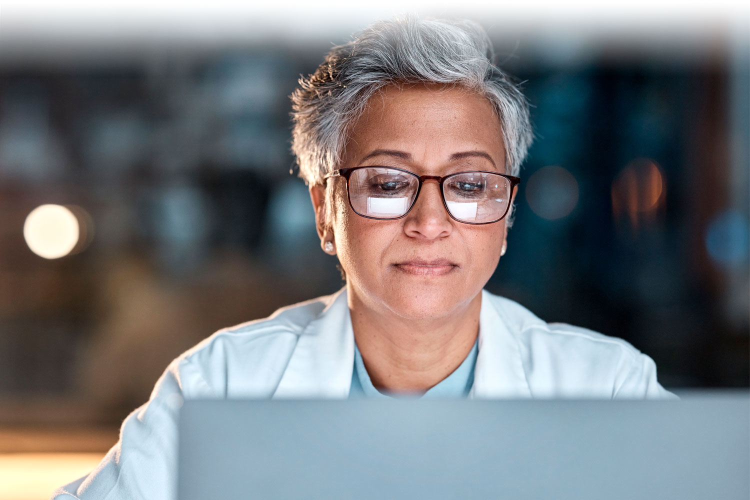 Healthcare professional looking at her computer screen