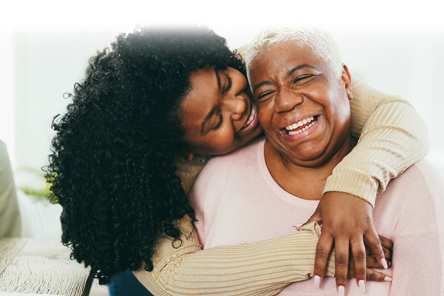 Daughter offering her mother comfort with a hug
