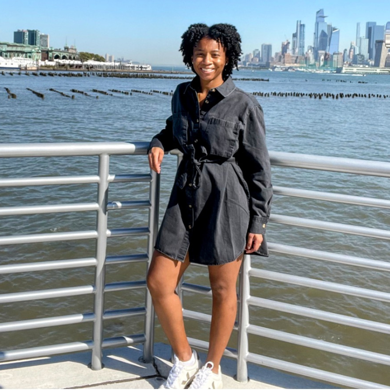 Natasha Kelly smiling with river and city in the background